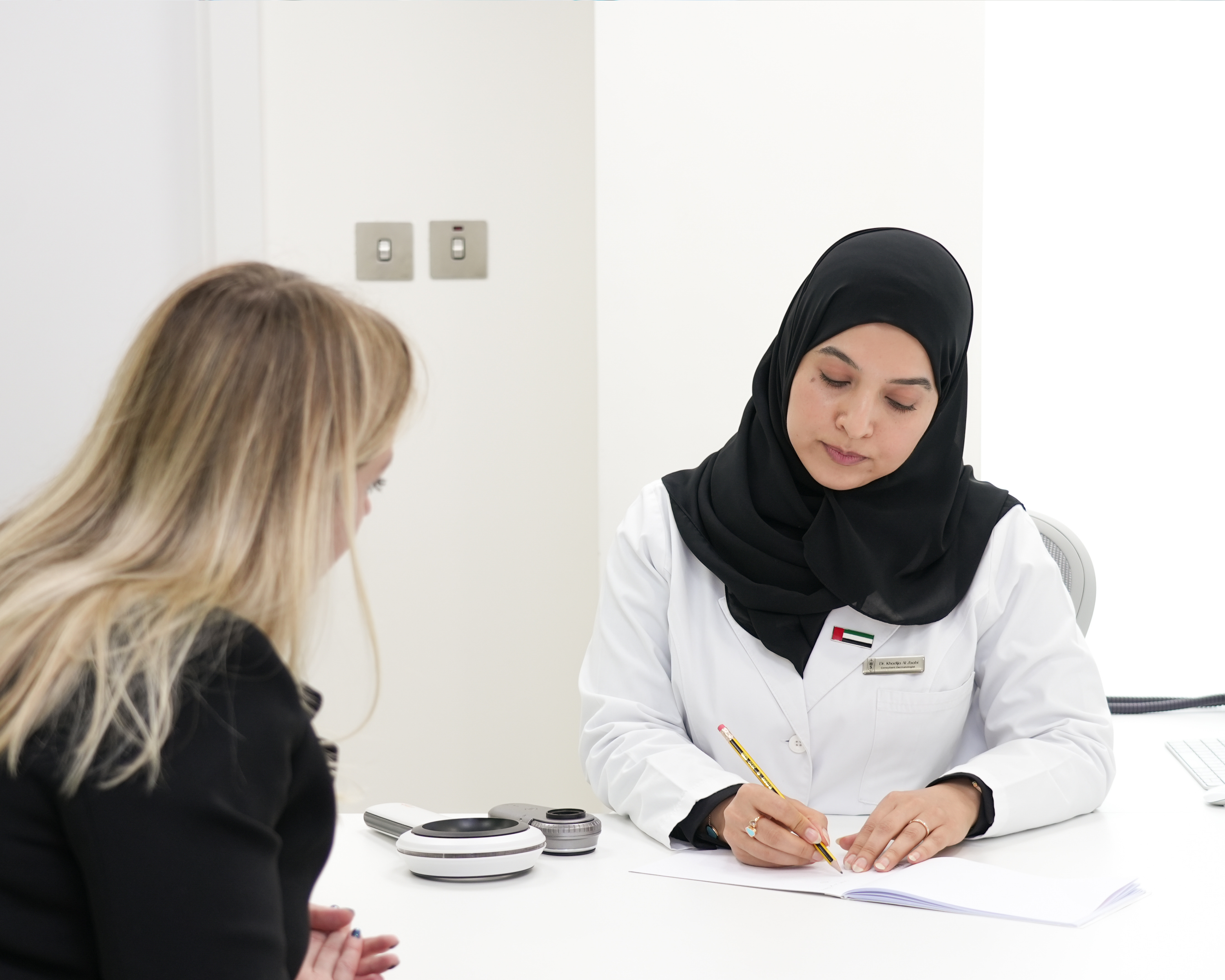Laser Hair Removal in Abu Dhabi — Smooth, Long-Lasting Results Dr. Khadija Al Zaabi consulting a patient about laser hair removal at House of Skincare, Abu Dhabi